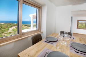 a dining room with a table with a view of the ocean at CasAfterlife in La Marmorata