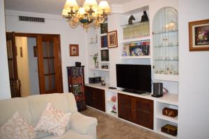 a living room with a couch and a television at Marruecos, 19 in Córdoba
