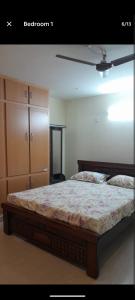 a bedroom with a bed and a dresser at RKVilla in Tirupati