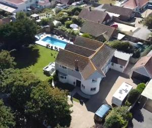 an aerial view of a house with a swimming pool at Stranraer House and pool in Selsey