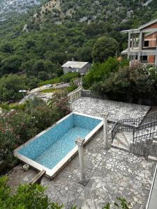 a swimming pool sitting on top of a stone patio at Villa Smokovac in Risan