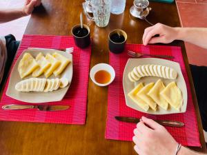 a wooden table with two plates of food on them at Local Homestay Du Gia in Ha Giang