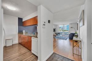 a kitchen with wooden cabinets and a dining room at Superb private unit with amenities and parking in Miami