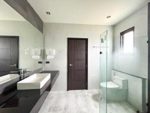 a white bathroom with a sink and a toilet at Modern House Uprompt Chiangmai in Chiang Mai +39 photos