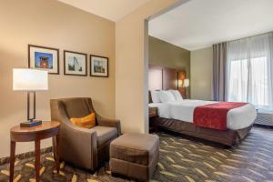 a hotel room with a bed and a chair at Comfort Suites Rolla in Rolla