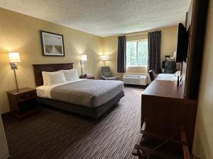 a hotel room with a bed and a window at Quality Inn near Toms River Corporate Park in Manchester Township