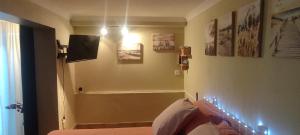 a room with a bed and some pictures on the wall at Studio 2 pers Haut Var in Saint-Julien