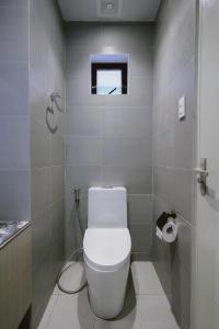 a white bathroom with a toilet and a window at ACHITEL Tarlac in Tarlac