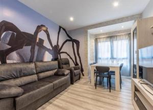 a living room with a couch and a table at La Bondad apartamento in Barakaldo