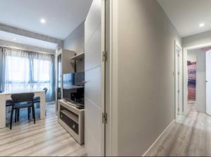 a kitchen with a table and a chair in a room at La Bondad apartamento in Barakaldo +9 photos