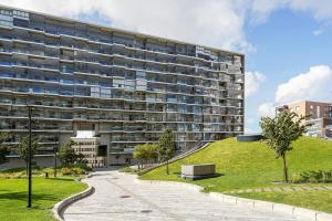 a large apartment building with a park in front of it at Mall of Tripla apartments by Come in! in Helsinki