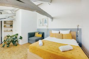 ベルサイユにあるLes Mansardes du Roi - Tout proche châteauの大きなベッドと椅子のある寝室