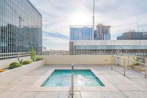 a swimming pool on the roof of a building at Bright & Stylish 2BR High-Rise Pool Gym Access in Phoenix +31 photos