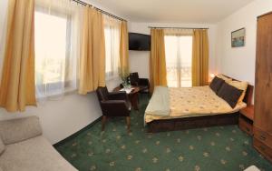 a hotel room with a bed and a chair at Klif Spa in Jarosławiec +70 photos