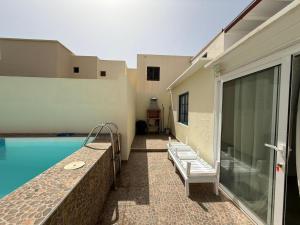 a balcony of a house with a swimming pool at Villa LiLo Private House with Heated Pool in Costa Teguise