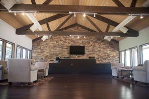 a waiting room with chairs and a flat screen tv at Soledad Canyon Cottage 2 in Ravenna