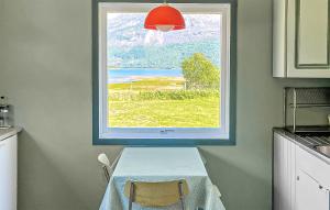 a window in a kitchen with a table in front of it at Cozy Home In Elvegard With Sauna in Elvegård