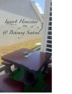 a wooden table with a cup on top of it at Iman4 Homestay in Kampung Behrang