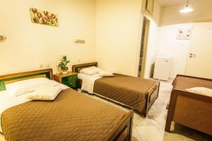 Postel nebo postele na pokoji v ubytování Hotel Atlantis