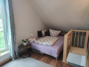 a small bed in a small room next to a window at Tiny Bauernhof Plau in Plau am See