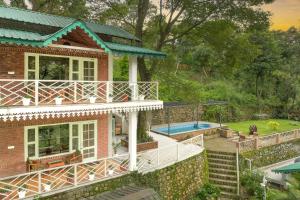 an aerial view of a house with a swimming pool at Echor Malusara Lakeview Retreat Bhimtal in Bhīm Tāl