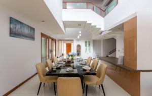 a dining room with a table and chairs at Thonglor 25 Noble House in Bangkok