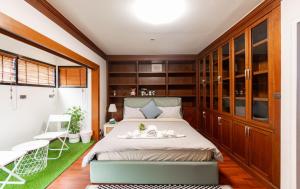 a small bedroom with a bed and a balcony at Thonglor 25 Noble House in Bangkok +25 photos