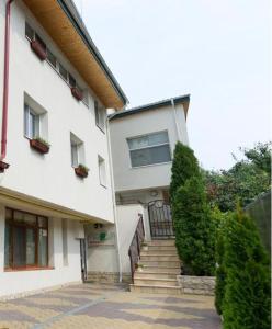 a white building with stairs and a stair case at Aparthotel Metropol in Iaşi