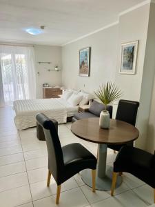 a living room with a bed and a table at Apartments Lavica Beach Dumičić in Podstrana