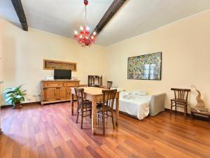 a living room with a table and a bed at Eulalia Apartment in Cagliari