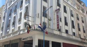 a large white building with flags in front of it at casa imobilier in Casablanca