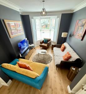 a living room with a couch and a table at SNUZE Whitby 2 in Whitby