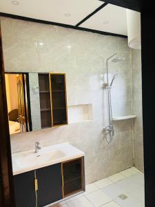 a bathroom with a sink and a shower at Résidence o-calme in Yaoundé +38 photos
