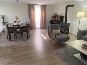 a living room with a table and a chair and a couch at Guest House Chalistavi in Chalist'avi