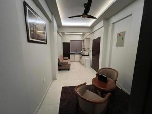 un salon avec un ventilateur de plafond et un canapé dans l'établissement Prestige comforts, à Karachi