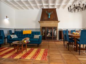 a living room with blue couches and a fireplace at L'Escale du Rhône de 1 à 8 personnes in Saint-Vallier