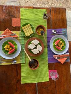 a table with plates of food on a wooden table at Sahana Retreat in Buttala +36 photos