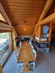 a dining room with a wooden table and chairs at Chalet Beyond - Gelinotte in Oz