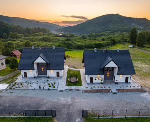 an aerial view of a house with mountains in the background at Solina Bóbrka Apartamenty PanDamazy 530-487-636z widokiem na kamieniołom i Zalew Myczkowiecki in Solina