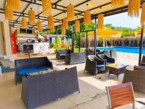 a patio with chairs and tables and a pool at Erendiz Garden Hotel in Kemer