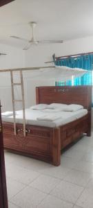 two beds in a room with a wooden bed frame at Sancanka Nungwi in Nungwi +17 photos