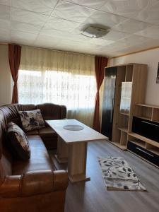 a living room with a couch and a coffee table at Apartament Iulia in Orşova