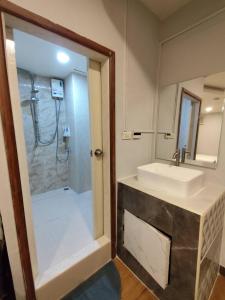 a bathroom with a sink and a shower at Longzhu Guesthouse in Bangkok +114 photos