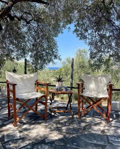 two chairs and a table on a patio at Sto Spiti Limani in Nea Skioni +24 photos