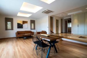 a living room with a table and chairs and a couch at Palm Tree Beach Villa in Kakongiónion