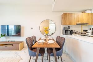 a dining room with a table and chairs and a mirror at Full Cleveland & Canal View - 5 min walk from Cleveland, ADGM and Galleria - Big Balcony - High Floor in Abu Dhabi