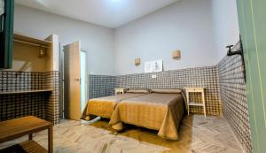 a bedroom with a bed in a room at Hotel Patio de las Cruces in Seville