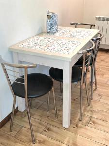 a white table with four chairs around it at Kielce City Center Old Town Rynek 4 bedrooms in Kielce