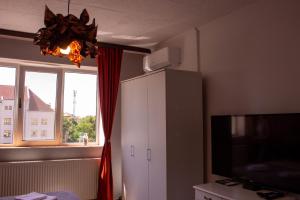 a room with a white cabinet and a window at Lyra Apartment in Sfântu-Gheorghe