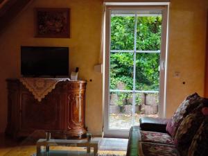 a living room with a large window and a couch at Ferienwohnung yuan in Bruchweiler-Bärenbach